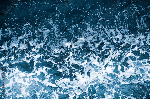 Aerial view of salt ocean waves. Blue water aqua sea background ot texture. Rippled spashing waves.