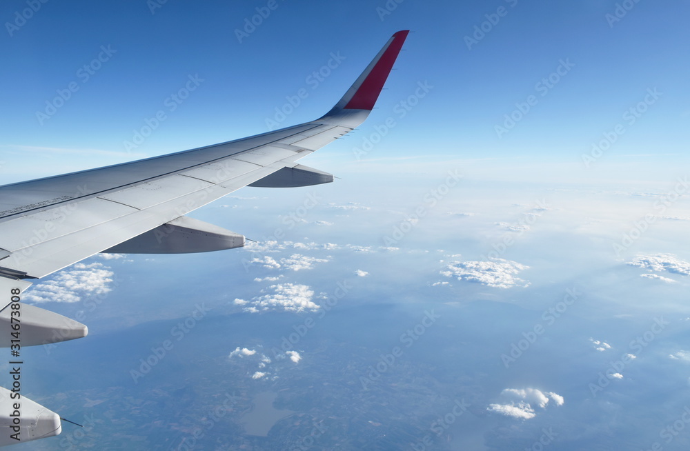 plane wing and cloud floating on sky through window frame plane wing and cloud floating on sky through window frame
