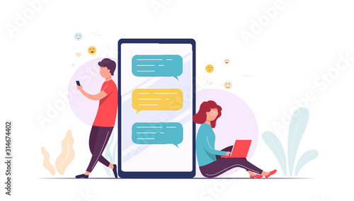 Couple using laptop smart phone communicate with each other. Pretty woman and man near large phone use mobile application to send messages, dating and relationships.