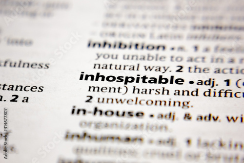 фотографія Word or phrase inhospitable in a dictionary.