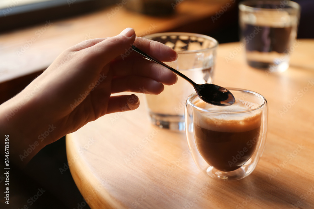 Woman with aromatic coffee at table in cafe, closeup Woman with aromatic coffee at table in cafe, closeup