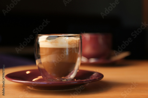 Aromatic coffee on wooden table in cafe. Space for text