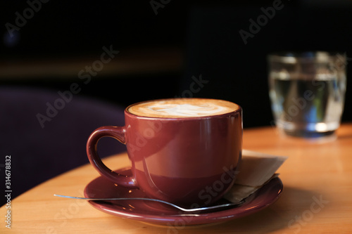 Aromatic coffee on wooden table in cafe