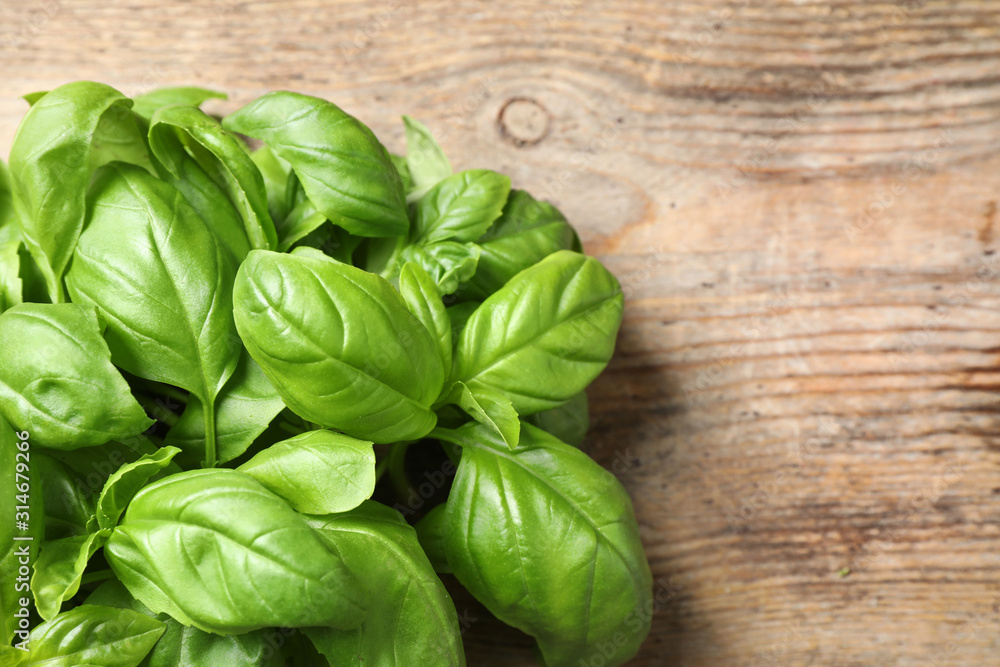 Fresh basil on wooden table, top view Fresh basil on wooden table, top view