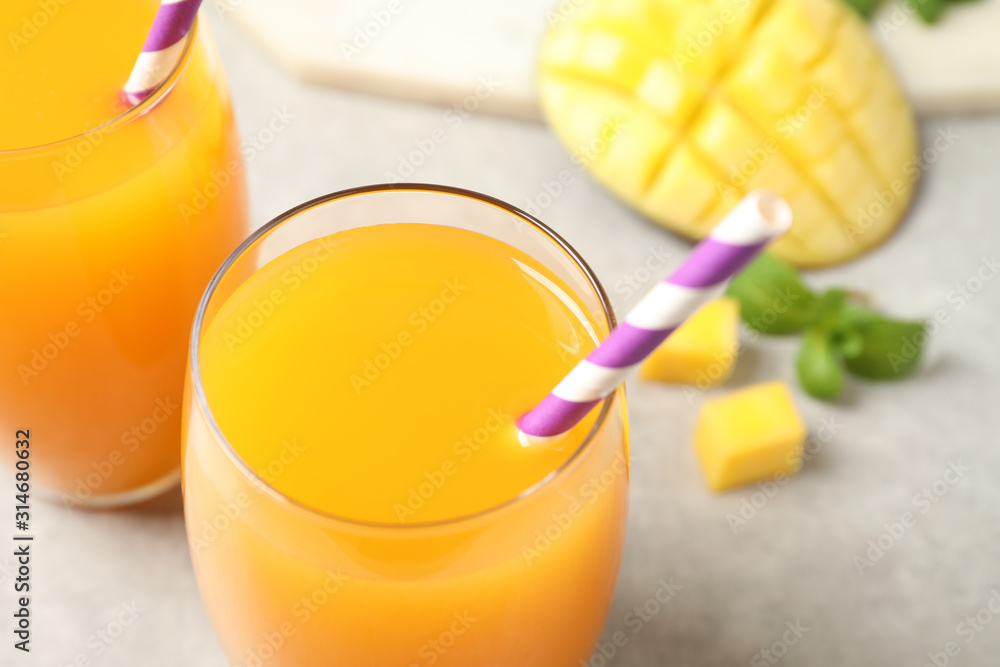 Fototapeta premium Fresh delicious mango drink on table, closeup