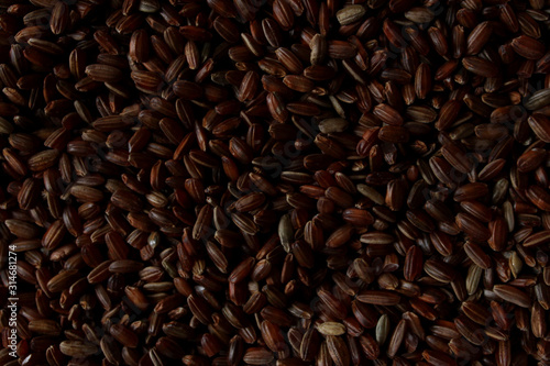 Cropped shot of uncoocked red rice  background. Horizontal image of brown rice.