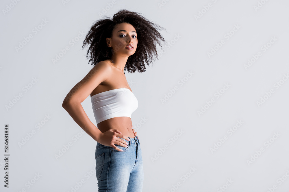 african american woman in white top isolated on grey african american woman in white top isolated on grey