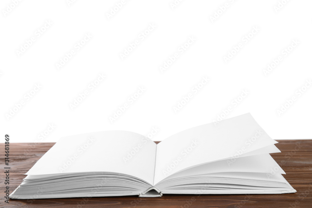 Open old hardcover book on wooden table Open old hardcover book on wooden table