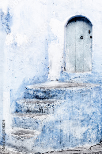 Stone staircase with old, wooden, blue door in Chefchaouen, Morocco. © Rosa Frei