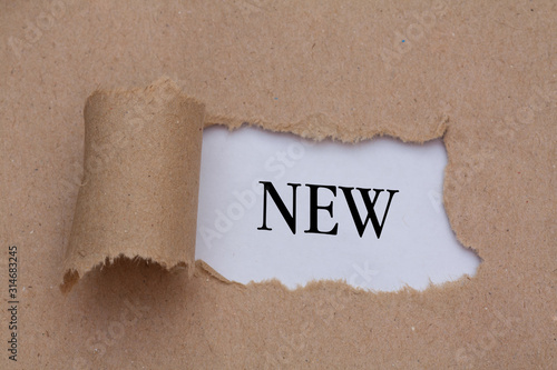 brown packaging paper torn to reveal new