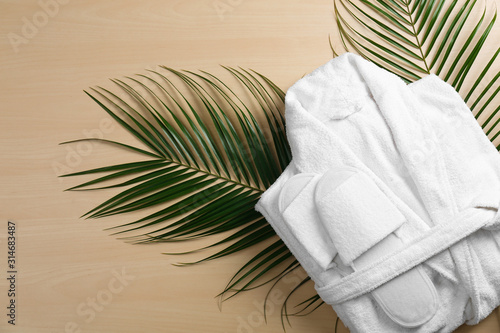 Canvastavla Flat lay composition with clean folded bathrobe on wooden background