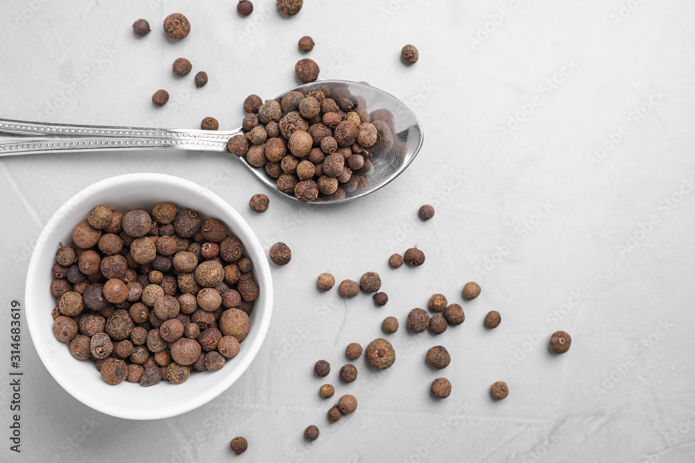 Black peppercorns on light table, flat lay Black peppercorns on light table, flat lay