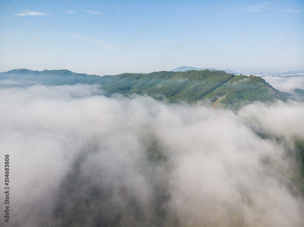Fototapeta premium Aerial view tropical rainforest morning sunrise with fog