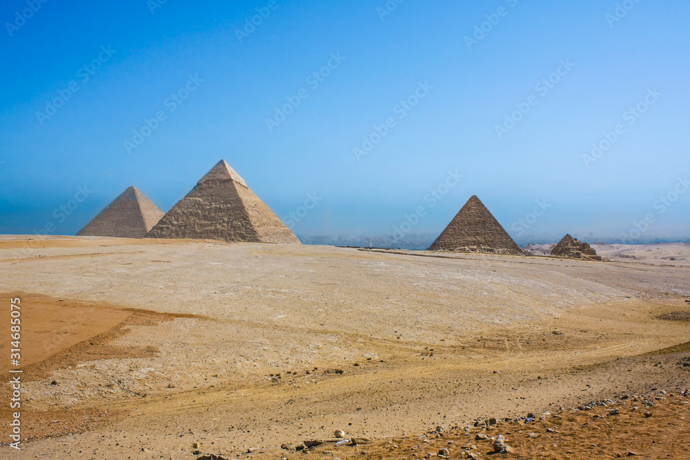 Great Pyramid in Giza, Egypt. Distant view from desert on Giza plateau with all famous pyramids.