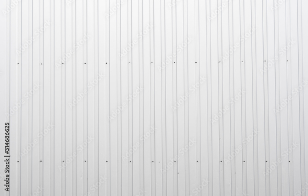 White Corrugated metal sheet texture surface of the wall. Galvanize steel background. White Corrugated metal sheet texture surface of the wall. Galvanize steel background.