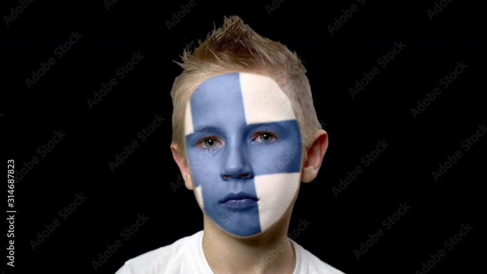 Sad fan of the football team of Finland. A child with a face painted in national colors. Unhappy boy with sad eyes. Fiasco of your favorite team. Disappointment. Sadness. Experience. Failure. Bad luck Sad fan of the football team of Finland. A child with a face painted in national colors. Unhappy boy with sad eyes. Fiasco of your favorite team. Disappointment. Sadness. Experience. Failure. Bad luck