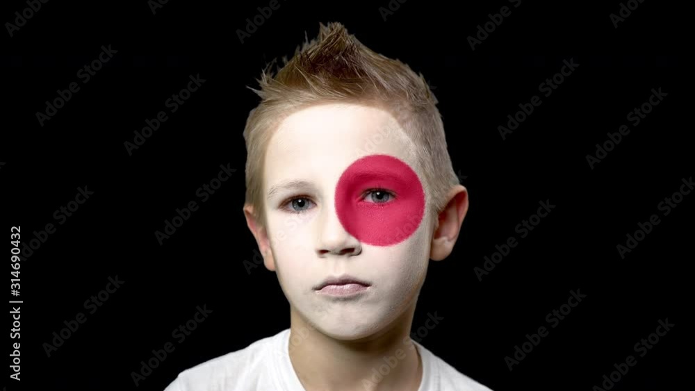 Sad fan of the football team of Japan. A child with a face painted in national colors. Unhappy boy with sad eyes. Fiasco of your favorite team. Disappointment. Sadness. Experience. Failure. Bad luck. Sad fan of the football team of Japan. A child with a face painted in national colors. Unhappy boy with sad eyes. Fiasco of your favorite team. Disappointment. Sadness. Experience. Failure. Bad luck.