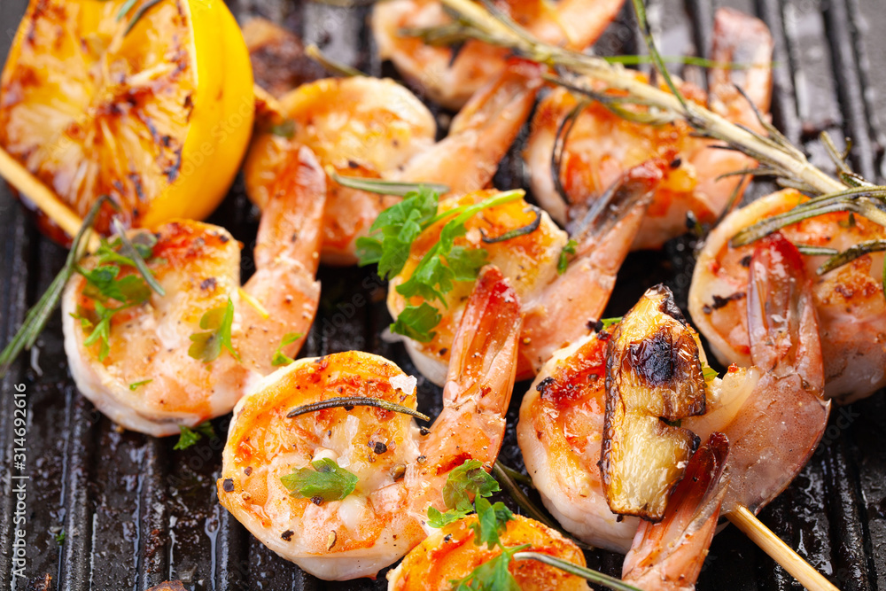 grilled shrimp on skewers. Grilled seafood on skewers with spices, herbs and lemon. delicious prawn. Grill. The iron grill. close up grilled shrimp on skewers. Grilled seafood on skewers with spices, herbs and lemon. delicious prawn. Grill. The iron grill. close up