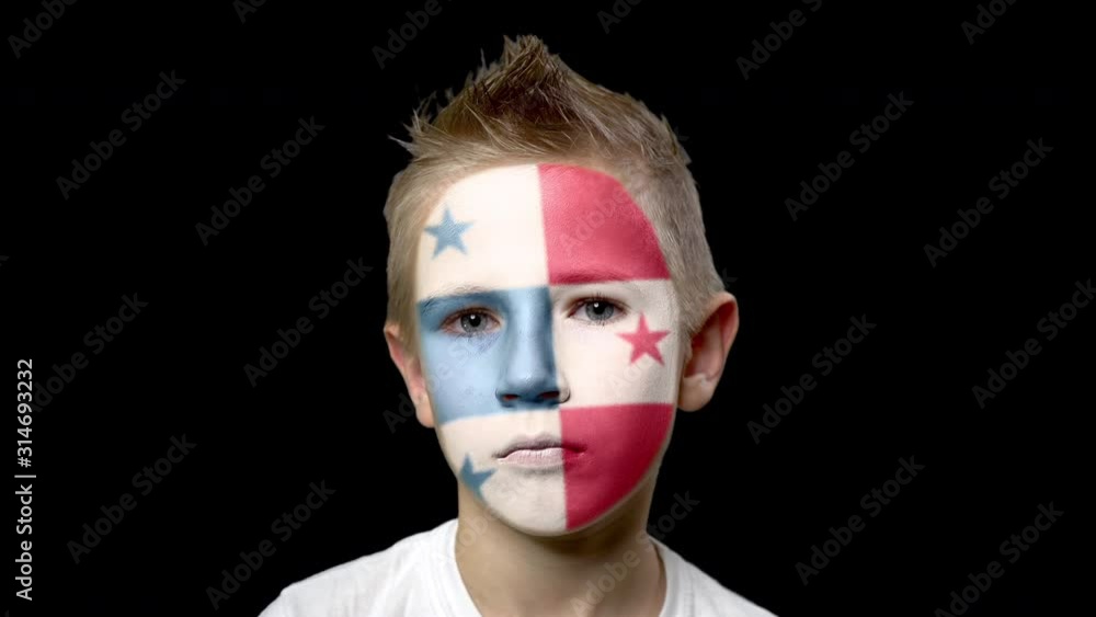 Sad fan of the football team of Panama. A child with a face painted in national colors. Unhappy boy with sad eyes. Fiasco of your favorite team. Disappointment. Sadness. Experience. Failure. Bad luck. Sad fan of the football team of Panama. A child with a face painted in national colors. Unhappy boy with sad eyes. Fiasco of your favorite team. Disappointment. Sadness. Experience. Failure. Bad luck.