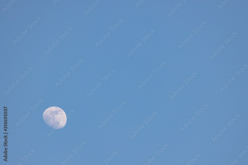 Waxing Gibbous Moon during the day on a bright blue sky Waxing Gibbous Moon during the day on a bright blue sky