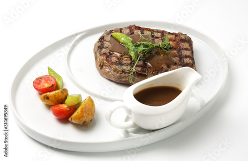 steak with sauce and vegetables on plate