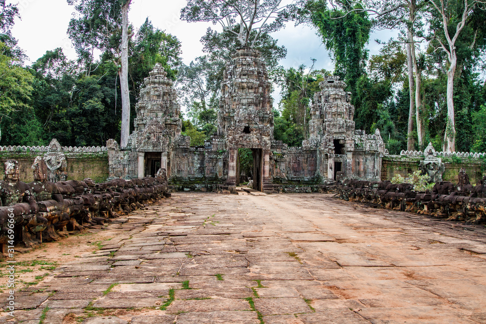 Temples of Angkor Wat where the jungle has partially overgrown the ruins near the city of Siem Reap in Cambodia Temples of Angkor Wat where the jungle has partially overgrown the ruins near the city of Siem Reap in Cambodia