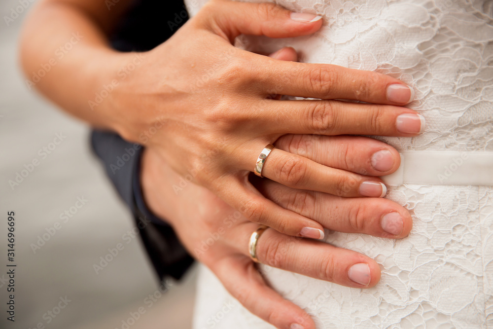 a pair of newlyweds hands with wedding rings a pair of newlyweds hands with wedding rings
