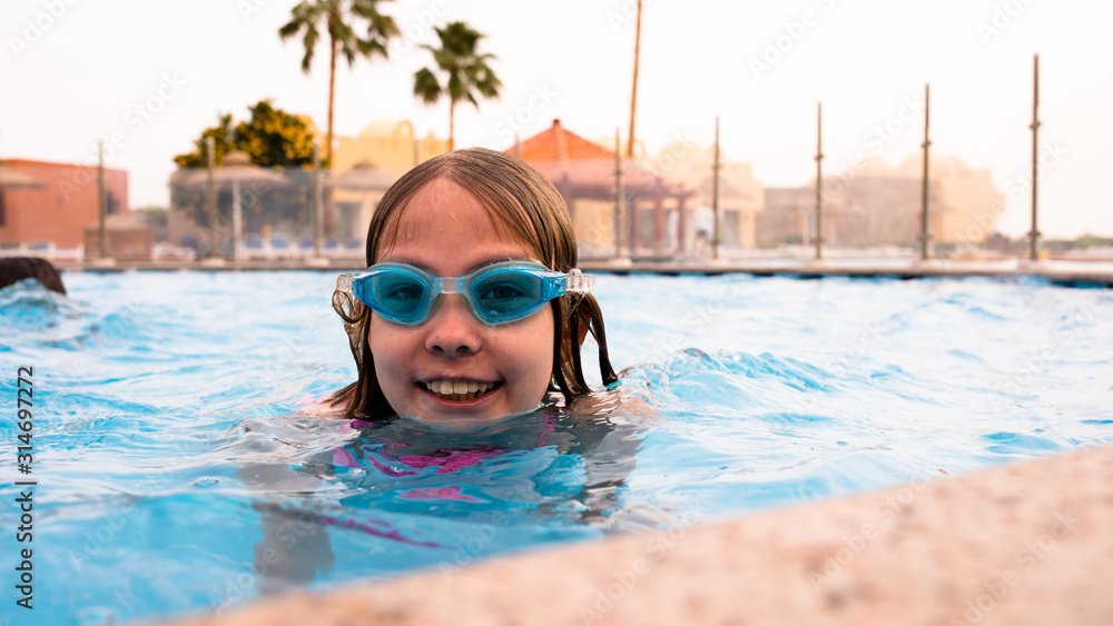 Underwater Young Girl Fun in the Swimming Pool with Goggles. summer concept. Summer Vacation Fun
