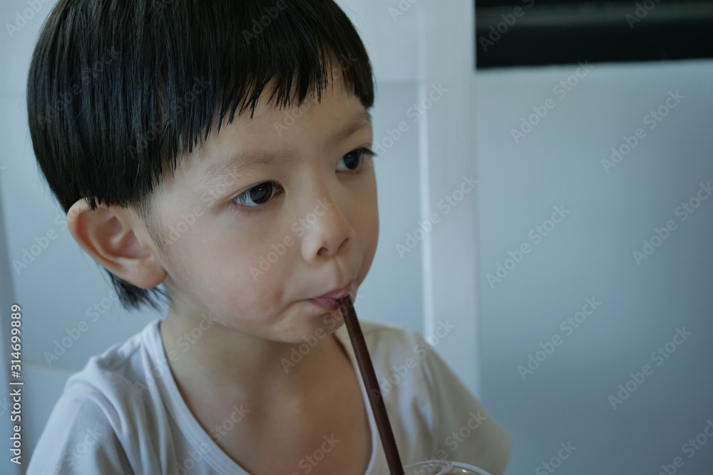 cute boy drinking water from straw cute boy drinking water from straw