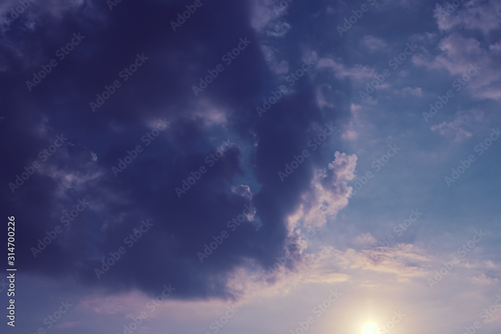 fluffy cloud above purple sky with sunlight in the morning