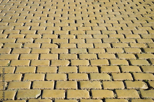 Texture of yellow urban stone pavement