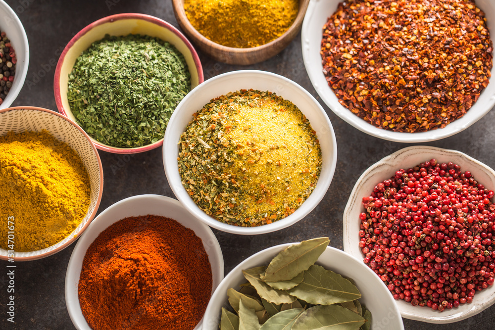 Set of variety aromatic spices and herbs in bowls Set of variety aromatic spices and herbs in bowls