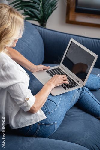 Woman on the sofa using her computer