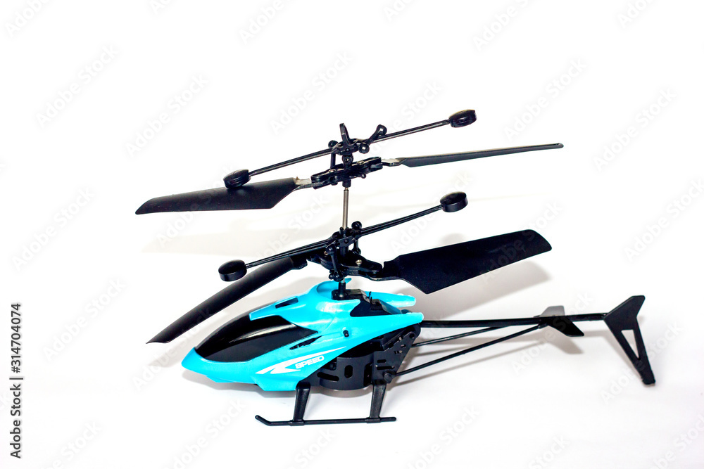 Helicopter isolated. Closeup of a little remote controlled toy helicopter isolated on a white background. Macro photograph of RC helicopter. Helicopter isolated. Closeup of a little remote controlled toy helicopter isolated on a white background. Macro photograph of RC helicopter.