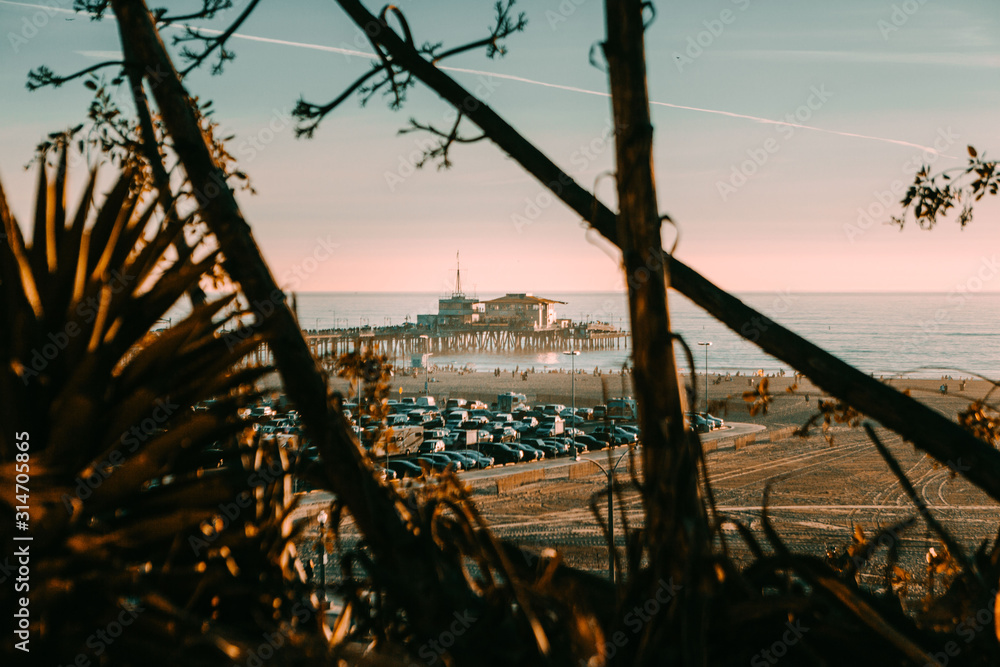 Obraz premium Sunset On The Pier Between Trees