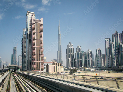 modern skyscrapers and Burdj-Halifa along the metro line in Dubai, UAE