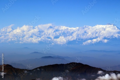 Fototapeta Naklejka Na Ścianę i Meble -  The Himalayas in the coulds / Enormous of the Himalaya ranges above the cloud and layer of dust over Nepal