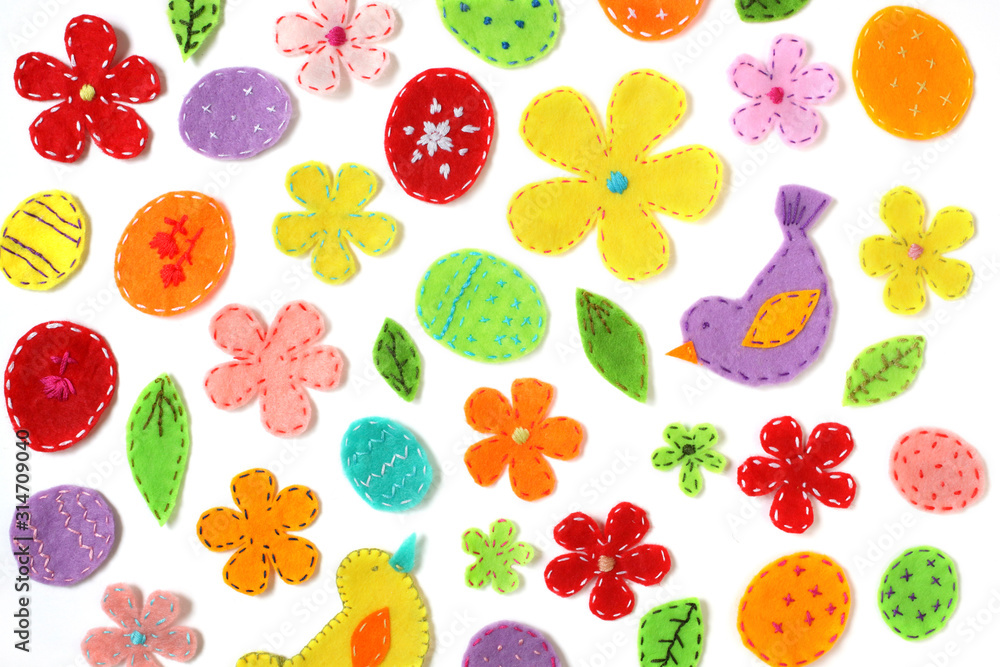 Easter background design on white. Spring backdrop of colored eggs, flowers, birds, leaves, decorated with embroidery. Easter background design on white. Spring backdrop of colored eggs, flowers, birds, leaves, decorated with embroidery.