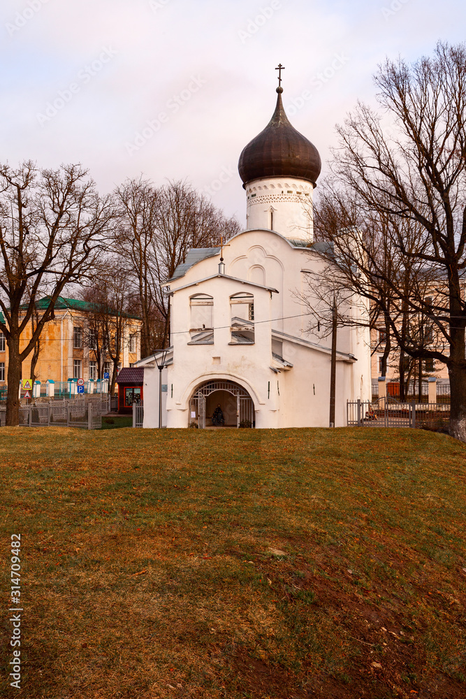 White-stone Orthodox church with black domes in the city of Pskov (Russia)