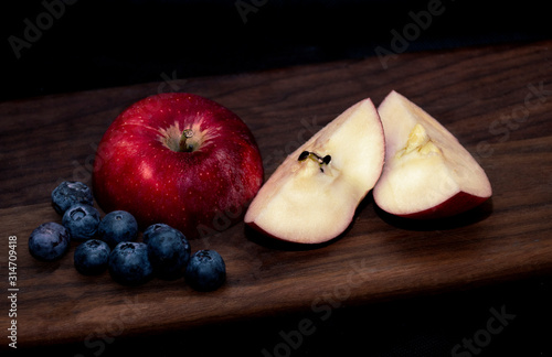 Fresh apples and blueberries on board vegetarian vegan