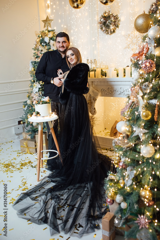 Stylish pregnant family, mom and dad in black family look, relaxing at