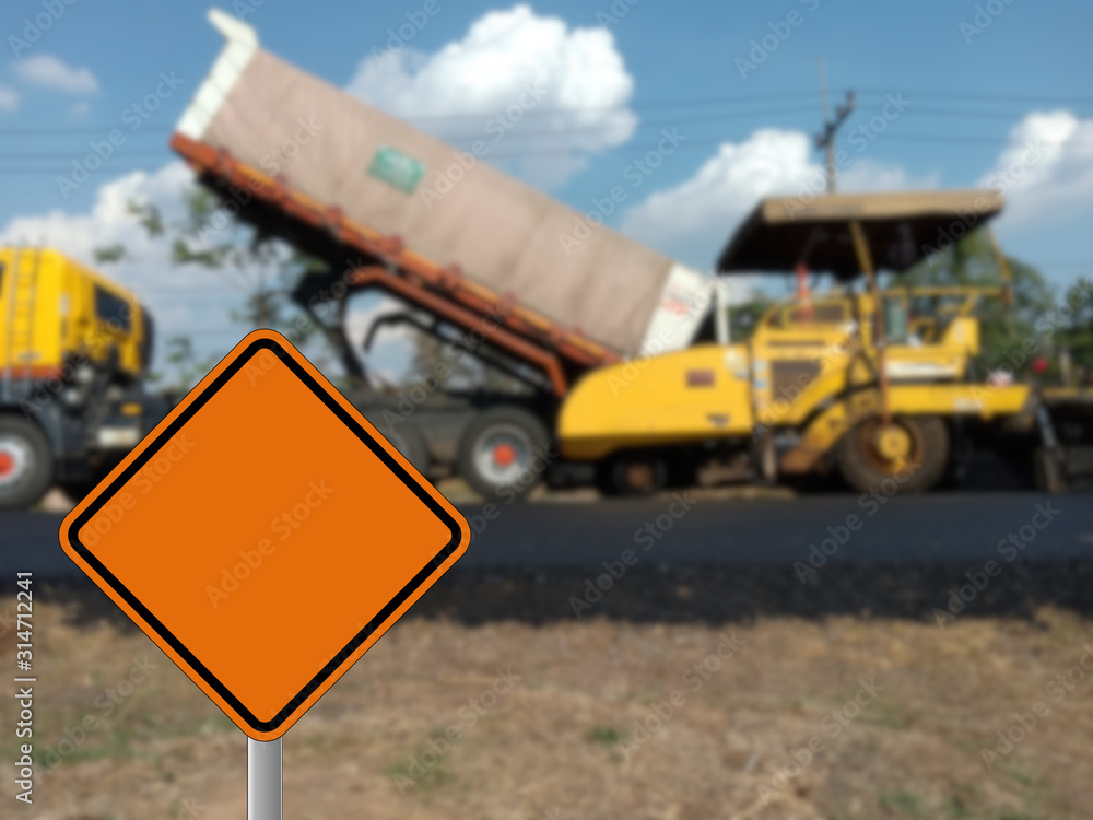 The construction of the image is blurry and there are construction warning signs. The construction of the image is blurry and there are construction warning signs.