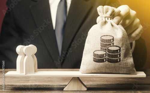 Man puts money bag and people on scales. Taxpayers concept. Decent salary pay for staff specialists. Business, crowdfunding startup. Investments in deposits. Social project financing. Labor migrants.