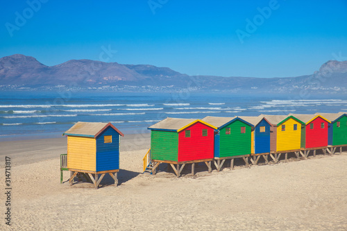 colorful beach huts on beach in muizenerg view to the sea