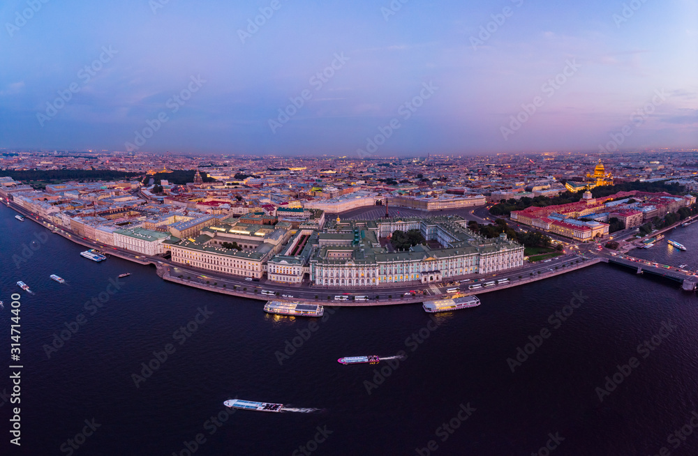 Beautiful aerial evning view in the white summer nights of St Petersburg, Russia, Hermitage at sunset, palace square, St. Isaac's Cathedral, The Alexander column, River Neva. shot from drone. Europe.