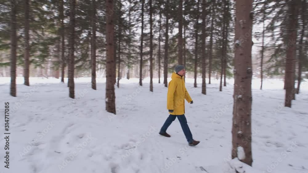 Portrait of a man in a yellow coat in the winter woods. Portrait of a man in a yellow coat in the winter woods.