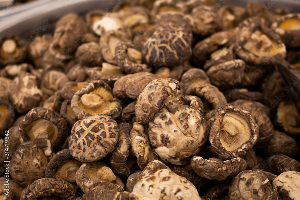 A closeup view of a pile of shiitake mushrooms, on display at a local retail store. A closeup view of a pile of shiitake mushrooms, on display at a local retail store.