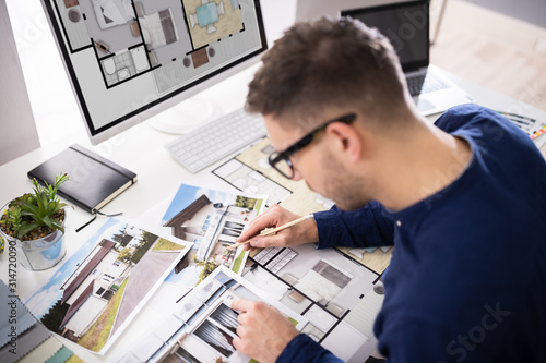 Real Estate Designer Working On Computer