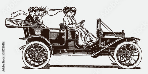 Group of historical people driving in an antique detachable tonneau car. Illustration after an engraving from the early 20th century