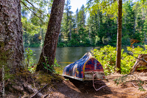 Old colorful canoe by lake on Vancouver Island, Sooke British Columbia